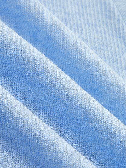 Top de punto fino semitransparente con botonadura diagonal y cuello